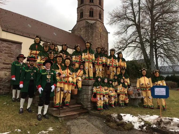 Gruppenbild der Schnecken mit Narrenrat vor einer Kirche